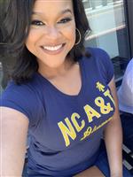 Woman smiling at camera wearing blue tshirt